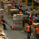 Workers collect customer orders during Black Friday deals week at an Amazon fulfilment centre in Hemel Hempstead, Britain November 25, 2015.